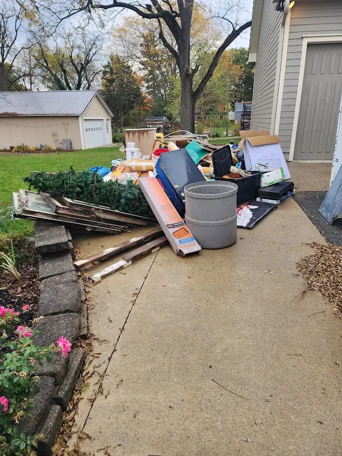 Dumpster being loaded with debris for Roofing Dumpster Rental in Elizabeth